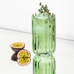  Tall, green glass cocktail or juice glass with a ribbed design. Made of durable, high-quality glass material.