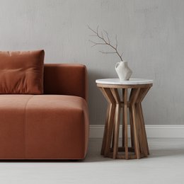  A round, white marble-topped side table with a wooden base in a modern, minimalist design. The table features a simple, clean aesthetic and is suitable for use as an end table or accent piece in a living room or bedroom.