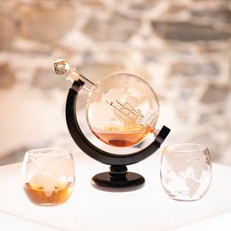  Globe-shaped crystal decanter with black stand, includes matching whiskey glasses, world map design, amber liquid display.