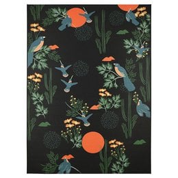 The BLOOM S indoor & outdoor designer rug features a vibrant floral and bird pattern in shades of green, orange, and black. The rug is suitable for both indoor and outdoor use, making it a versatile addition to any space.