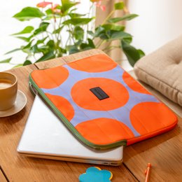  Tangerine sky laptop case with a bold, geometric pattern in shades of orange and gray. Made of durable, water-resistant material with a zippered closure for secure storage.