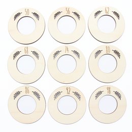 Wooden leaf-shaped baby hangers in neutral colors, suitable for organizing and storing baby clothes.