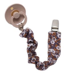 Pacifier holder with floral print, featuring a chocolate-colored pacifier clip and a chain to attach to clothing. The holder has a round, ruffled design with a mix of brown, pink, and white floral patterns.