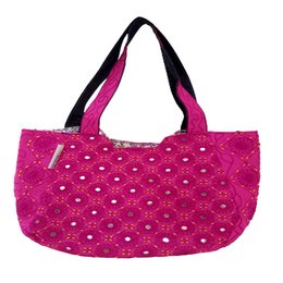 A vibrant, fuchsia-colored tote bag with a diamond-shaped quilted pattern and black trim. The bag appears to be made of a durable, textured material, likely cotton or a similar fabric. The design features a simple, yet stylish aesthetic that would be suitable for everyday use or as a fashionable accessory.