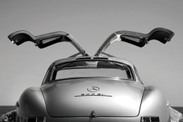 A silver sports car with distinctive gull-wing doors.