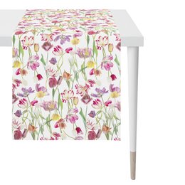 This colorful table runner features a vibrant floral pattern with a variety of flowers and plants in shades of pink, purple, and green. The runner is 48 inches by 140 inches in size, making it suitable for use on a dining table or other long surface.
