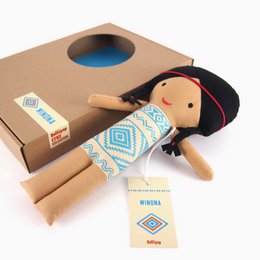 Soft, plush baby doll with long black braided hair and a patterned dress in shades of blue and white. The doll is named Winona and is packaged in a cardboard box.