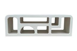  A modern, minimalist lowboard with a geometric, modular design featuring multiple open compartments and shelves in a neutral white color.