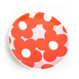 A red and pink floral jewelry box with a round shape and a decorative pattern of overlapping flowers.