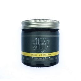 Lemon and bergamot cleansing balm in a 60ml jar with a silver screw-top lid. The product has a dark blue label with yellow accents.
