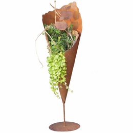 Tall, rust-colored metal planter vase with a stick-on base plate, suitable for displaying blooming plants or greenery. Dimensions: 69 cm or 83 cm in height.