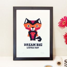 Whimsical woodcut-style print featuring a playful, superhero-inspired cat character with the text "Dream big little cat". The print is suitable for a child's room or nursery decor.