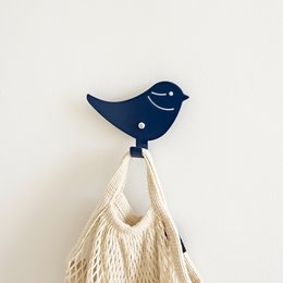 Blue bird-shaped wall hook for hanging kids' clothing and accessories.
