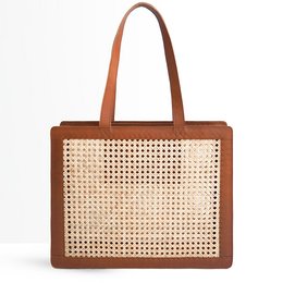 A brown leather shoulder bag with a woven cane pattern, featuring two handles and a rectangular shape.