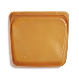 Honey-colored food wrap container with a clear lid, containing a light-colored substance that appears to be honey or a honey-based product.