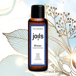A 100ml bottle of Joils Winter essential oil blend, featuring a dark blue label with the Joils logo. The bottle is surrounded by illustrated winter foliage in shades of gold and blue.