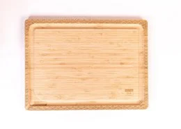 Bamboo cutting board, natural wood, rectangular shape, wave pattern border, decorative carved edges, kitchen prep board.