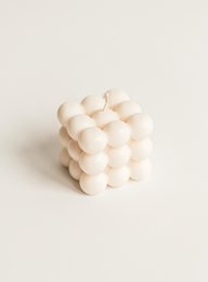 Bubble-shaped white pillar candle with a textured surface, creating a soft, cozy ambiance.