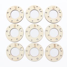 Wooden hangers with moon and star designs, suitable for children's clothing or decor.