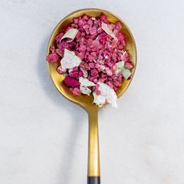 Aromatic salt blend with vibrant pink and red hues, featuring a mix of spices and herbs.