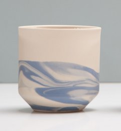 Blue and white swirled ceramic mug with a simple, minimalist design.