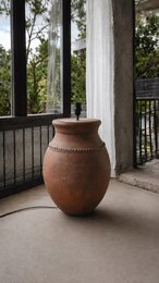  Terracotta rustic round bulbous floor lamp with textured clay material, earthy brown tone, traditional pottery style.