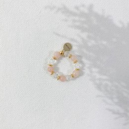 A delicate ring with a wreath of pastel-colored flowers, perfect for a spring wedding.