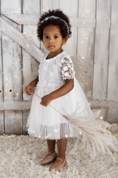 A white tulle dress for girls, featuring a high neckline, short sleeves, and a full, flowing skirt. The dress is available in sizes ranging from 92-98 cm to 158-164 cm, suitable for girls of various ages.
