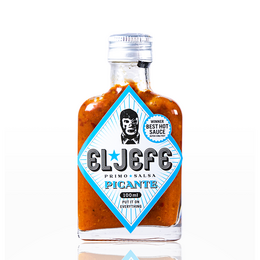 Spicy hot sauce in a glass bottle with a label featuring the brand name "Cliff" and the text "Picante". The sauce appears to be a vibrant orange color.