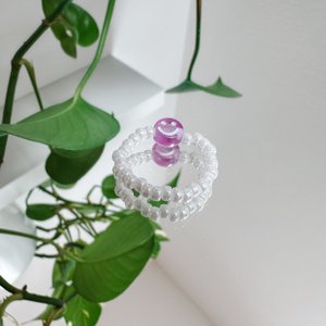 Pearl ring made of white glass beads with a purple smiley