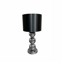 A chrome table lamp with a black cylindrical shade and a stacked glass base.
