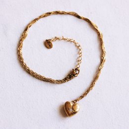 Fine twisted chain with a small heart and a crystal stone