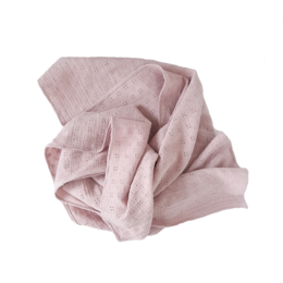 Soft, delicate swaddle blanket in a light pink color with a subtle eyelet pattern. Suitable for wrapping and comforting newborns.