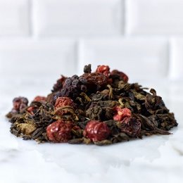 A blend of dried tea leaves, rose petals, and other natural ingredients. The tea has a rich, aromatic flavor and a deep reddish-brown color.