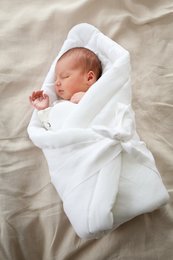 Soft, cozy linen baby wrap in a variety of neutral colors including caramel, beige, gray, white, sea blue, forest green, and powder pink. Perfect for swaddling and keeping newborns warm and secure.