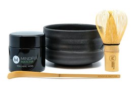 Organic matcha tea set with ceramic bowl, bamboo whisk, and matcha powder. Includes details on color, material, and style.