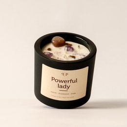 Powerful lady scented candle with gemstone accents, featuring a round, tall shape and a black container.