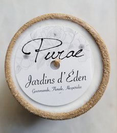 Tall, round, scented candle with "Purae Jardins d'Eden" label and natural jute texture.