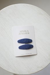 Dark blue oval hair clips made of soft denim fabric, suitable for kids' hair accessories.