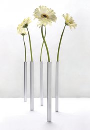 Peleg Design Magnetic Vases - Tall, cylindrical vases in silver and gold colors, featuring a minimalist, modern design.