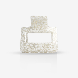 A white, rectangular hair clip with a dotted pattern, suitable for holding hair in place.