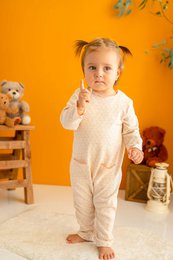 Cream-colored baby girl's overall with snap buttons, suitable for ages 3-24 months.