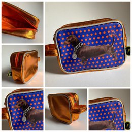  Blue toiletry bag with dachshund dog design, gold metallic trim, polka dot pattern, rectangular shape.