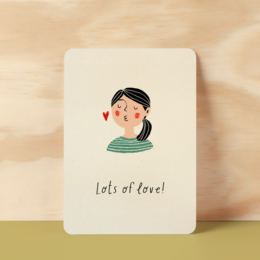 A postcard with a cute illustration of a person's face and the text "Lots of love!" This postcard is part of the Friendship Cards category.