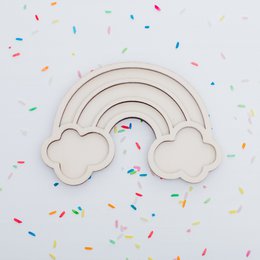  Colorful rainbow-shaped wooden sensory toy with textured surfaces and shapes.