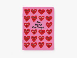 Lavender-colored notebook with the text "Dogs I Like More Than People" printed on the cover.