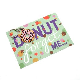 Colorful donut-shaped keychain with a postcard-style design featuring the text "Donut Forget Me!".