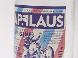 Dry gin with 43% alcohol content, featuring a bold, artistic label design with a motorcycle motif.