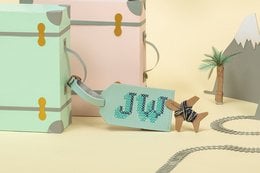 Mint-colored luggage tag with Stitch character design, made of durable material for smartphone cases.