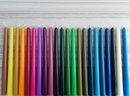 Pastel color 10" beeswax taper candle in a variety of colors including yellow, pink, purple, green, and blue. The candle has a simple, cylindrical shape and is made of beeswax.